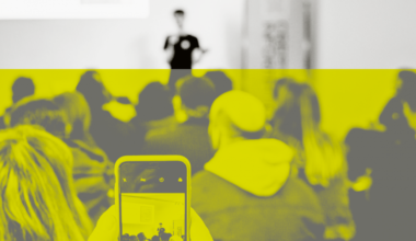 Someone filming presentation on their phone