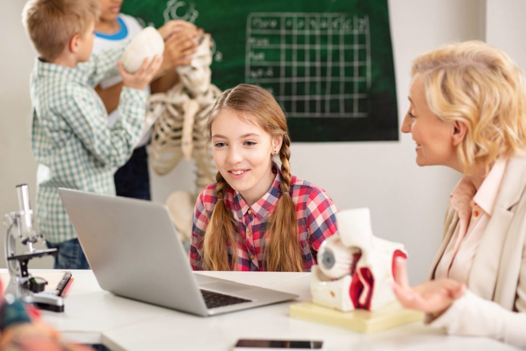 Woman teaching young girl
