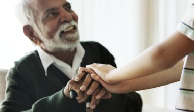 Grandson holding grandpa's hands