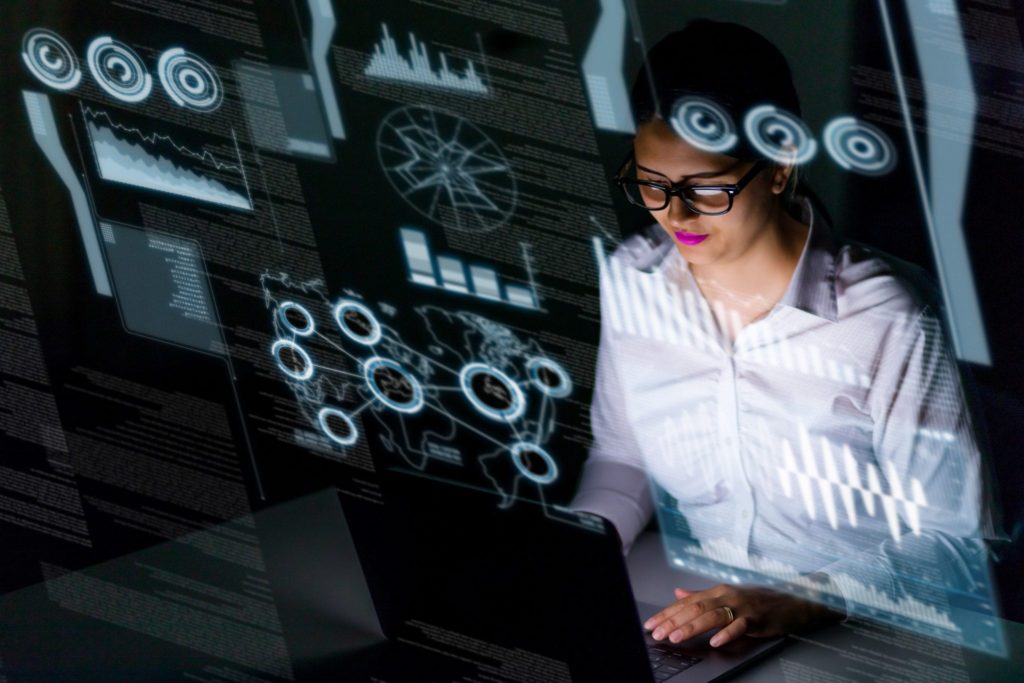 woman with laptop showing graphs