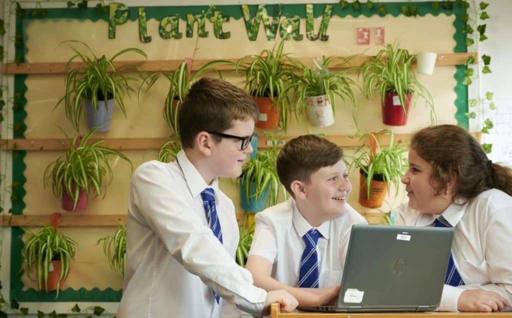 Photo of Primary 7 pupils from Addiewell Primary School monitoring the positive effect of their plant wall on CO2 levels in thier classroom. Credit, Callum Bennetts, Maverick Photo Agency