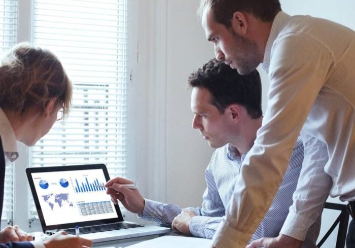 3 people looking at a screen